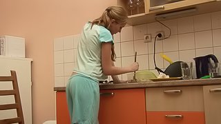 Petite Jessica Neight plays with her shaved pussy in the kitchen