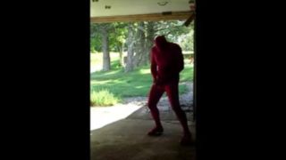 red zentai jerking off at garage door