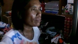 Mature Filipina kneads and licks her flabby boobs in webcam solo