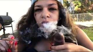 Slutty brunette smoker blowing a black cock outside in POV