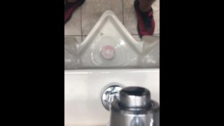 Pissing at public bathroom while other people are in the place