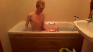 Blonde teen takes a warm bath in the bathtub
