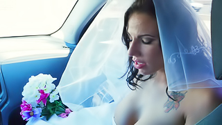 A woman gets penetrated in her wedding gown on the bed