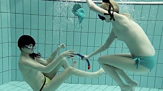 Two adorable white teen ladies in the pool feeling frisky