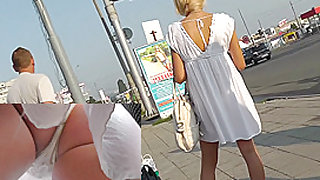 Tight ass of the young blonde caught on the upskirt cam
