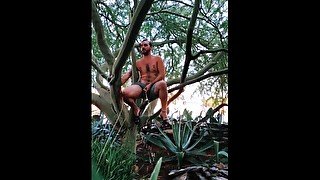 Nudist Hippie peeing from a tree