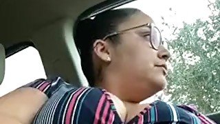 Busty woman in glasses masturbates in car