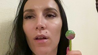 Brunette with big tits masturbates with a lollipop