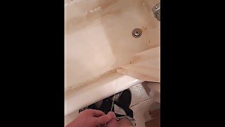 Pissing in my shower in my upstairs bathroom and fondling my dick and balls)