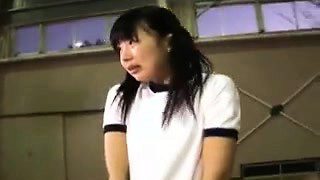 Pigtailed Asian schoolgirl works her lips and hands on a lo