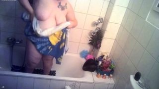 Big breasted amateur granny taking a shower on hidden cam