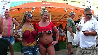 Body painted beauties playing at a street fair