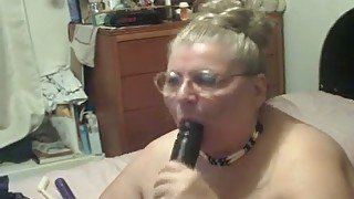 Old fat webcam whore in glasses sucks big dildo on webcam