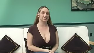 Chubby cougar with massive natural tits playing with a vibrator on her sofa