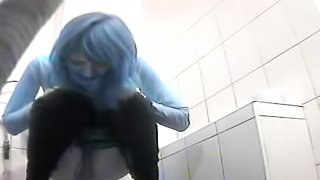 Blue haired babe is peeing in the toilet