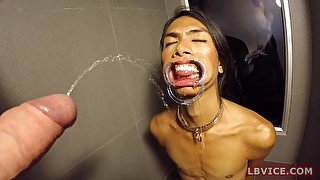 Thai femboy Cat is on the dirty floor of hotel bathroom and looking right on guy's dick in front of her face.