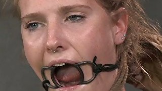 Blonde slave with a ring gag in her mouth is bounded and punished