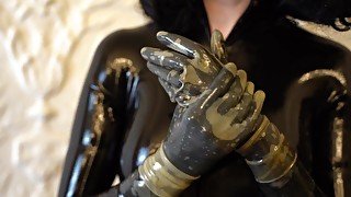 Trying on transparent latex gloves on a catsuit